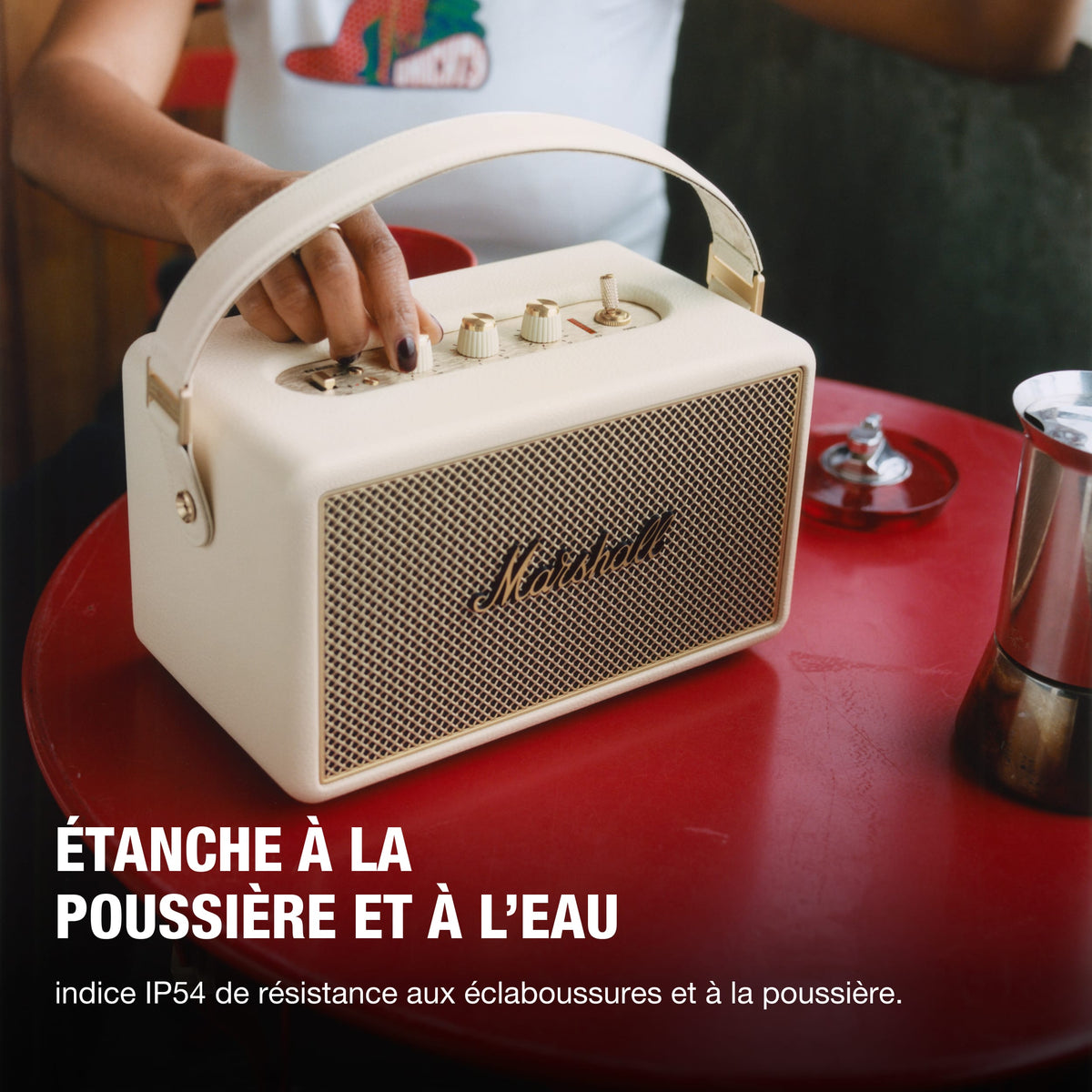 Marshall – Kilburn III - Portable Speaker - Cream, cream-coloured Marshall portable speaker placed on a red table