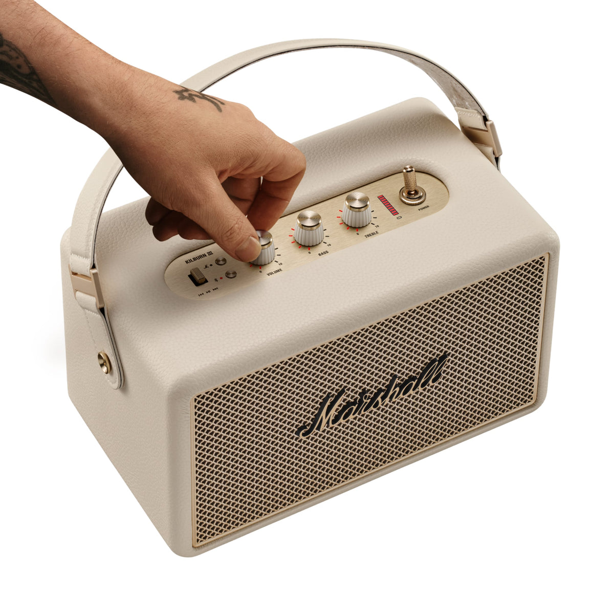 Marshall – Kilburn III - Portable Speaker - Cream, beige portable speaker with a strap handle, a hand adjusting a knob