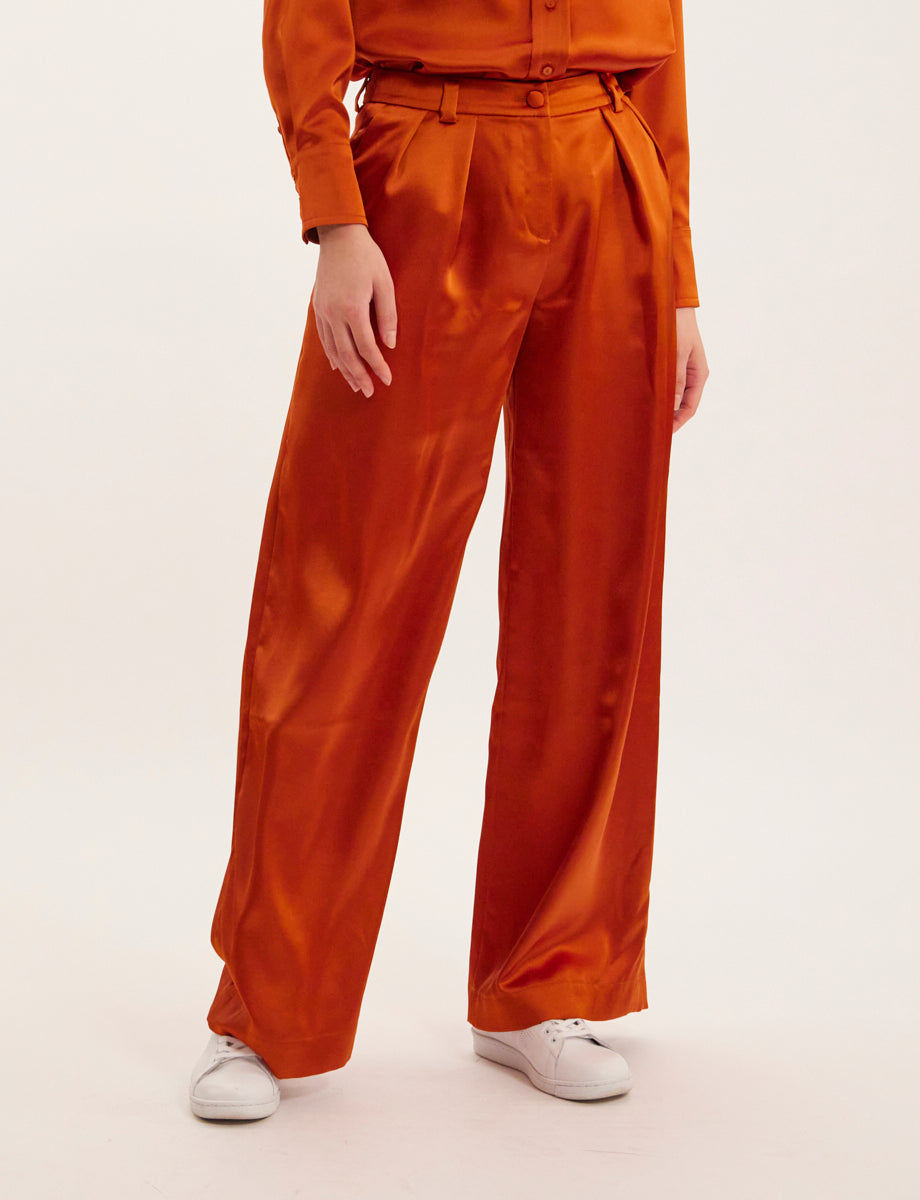 Ines De La Fressange – Luciano Trousers - Rust, orange satin wide-leg trousers worn by a model, front view