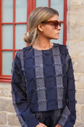 A cropped cut and fringes, nothing better as a piece that stands out from the crowd with the Anatole top with navy fringes. 