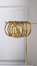 Brazalete budista retorcido - oro claro