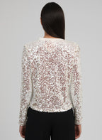 An'ge – T-Shirt Abela Ecru, veste à sequins portée de dos par un mannequin aux cheveux bruns