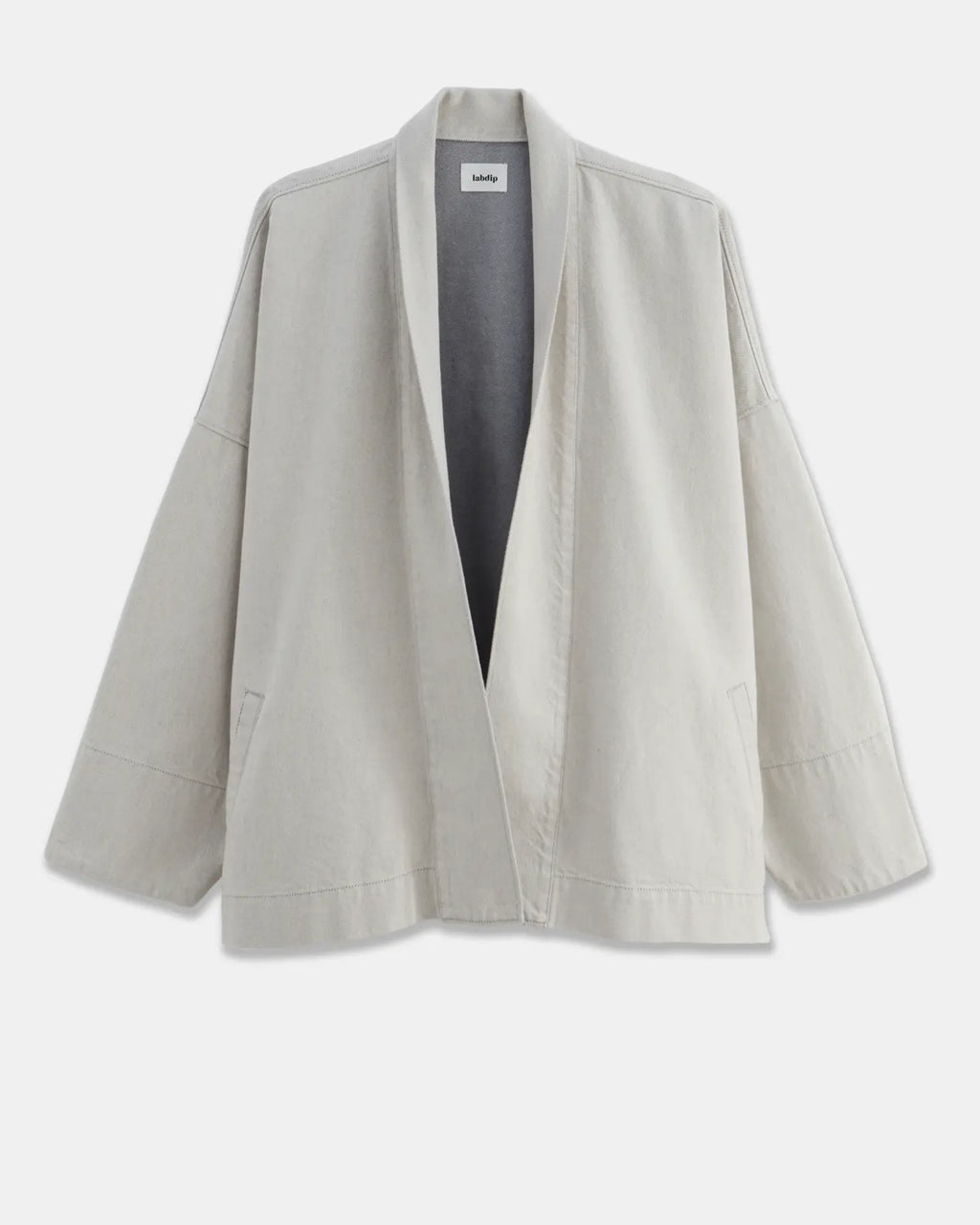 Veste ample en coton léger de couleur granit non teint, avec un col châle et des manches larges, parfaite pour une silhouette décontractée et confortable.
