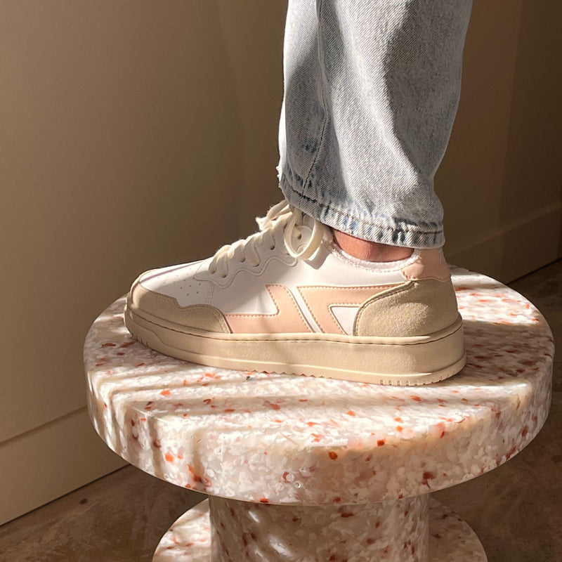 Par de zapatillas desgastadas en blanco y rosa. 