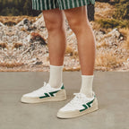 Comfortable sneakers with thick sole. White and green sneakers in plant materials