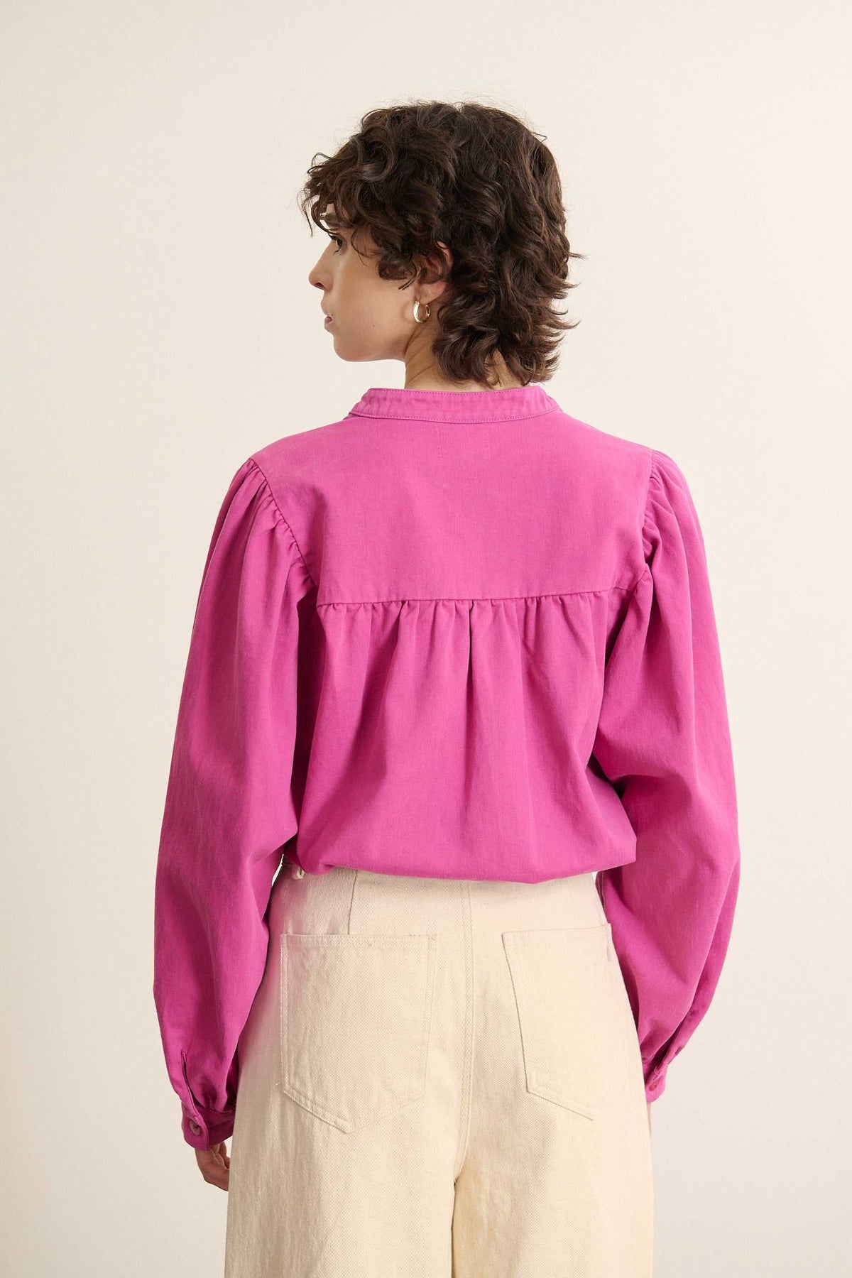 Vue arrière de la blouse ample, coupe évasée avec empiècement haut et fronces réparties sur toute la largeur. 