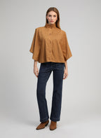 An'ge – Veste Christelle Camel, mannequin portant une cape courte marron et un jean bleu foncé