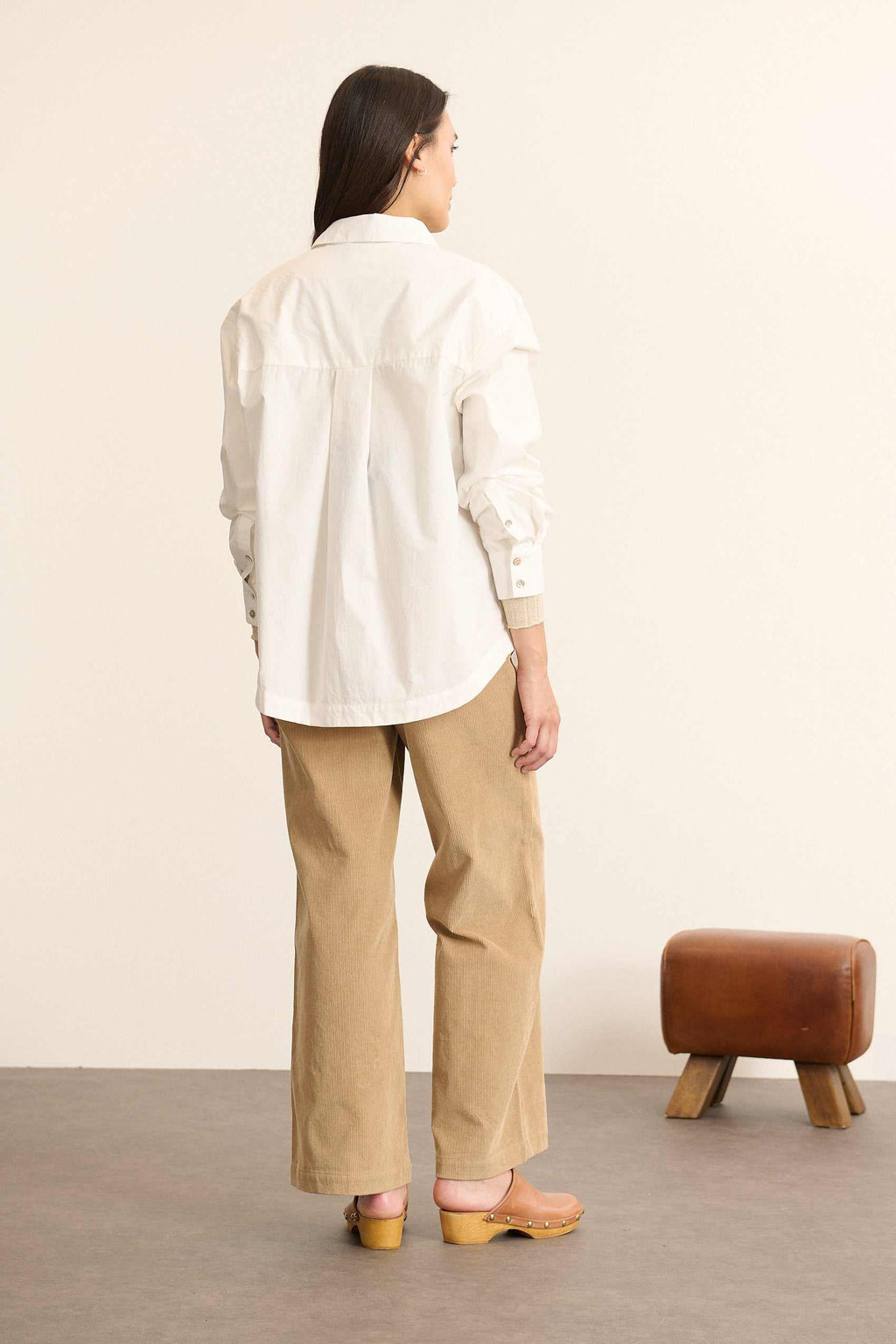 Vue arrière de la chemise ample, découpe horizontale haute avec fronces légères pour créer du volume au dos. 