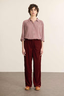 Mannequin femme de face portant une chemise en vichy bordeaux, coupe ample avec col chemise et fronces devant et de dos.