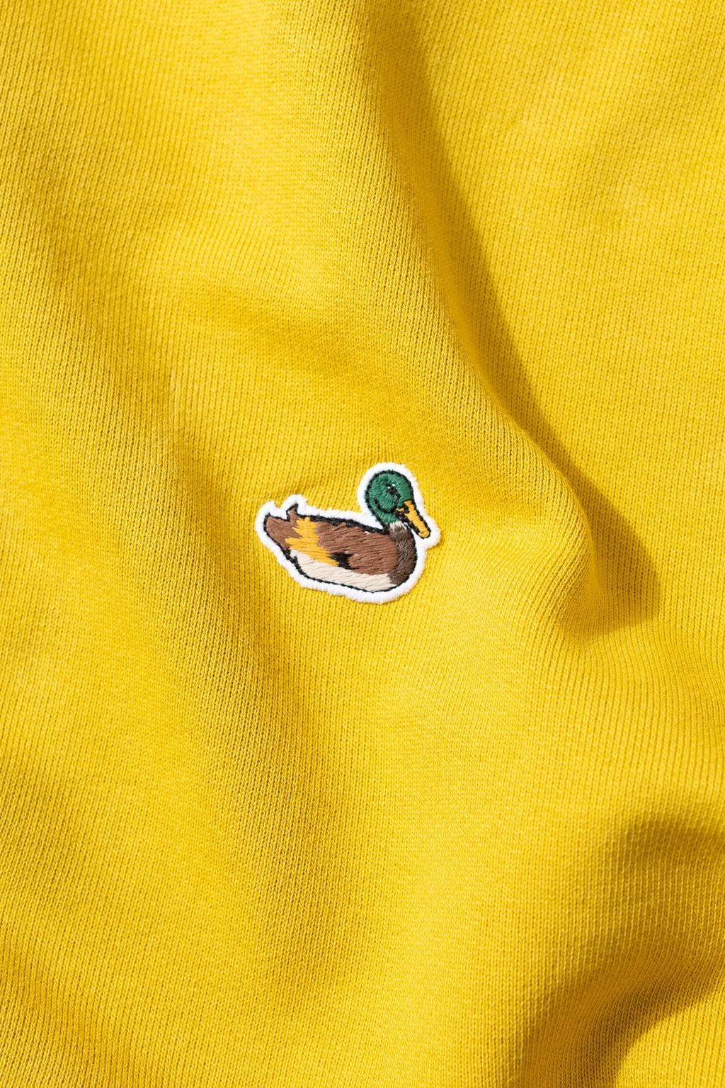 Sudadera Lisa Parche Pato Mostaza