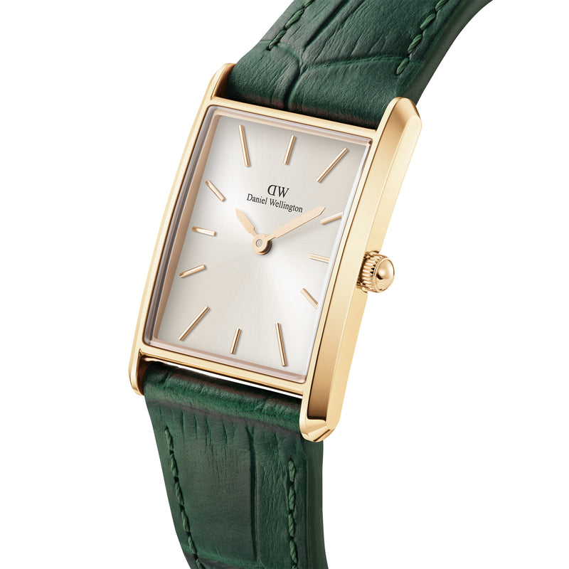 Reloj encuadernado en cuero de cocodrilo verde color champán y dorado con rayos de sol