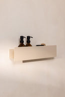 Duschablage SHEA mit Pflegeprodukten auf einer hellen Wand en diseño minimalista en aluminio.