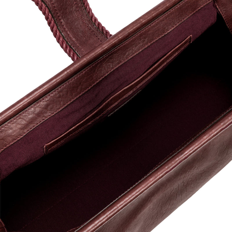 Close-up of a burgundy in a shade of dark cherry leather with a same tone interior and card slots