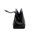 Black leather handbag with an open rope closure on a white background