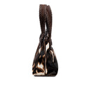 Dark brown and cream cow print pattern small tote bag with dark brown rope handles on a white background, shown from the side.