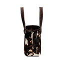 Dark brown and cream cow print pattern tote bag with open dark brown rope handles on a white background, shown from the side.