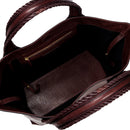 Close-up of a burgundy leather in a shade of dark cherry bag with a same tone interior. It has an inner pocket with zip and keys strap.