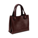 Burgundy leather in a shade of dark cherry tote bag with rope handles on a white background. When the inner straps are joined, the bag takes on a more rounded shape.