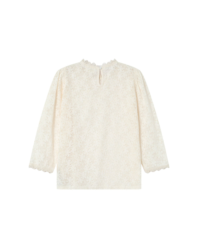 Blusa Stella color crudo con cuello levantado