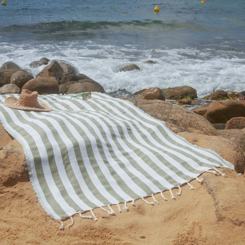 Woman using an Olive Green Positano Fouta - BY FOUTAS