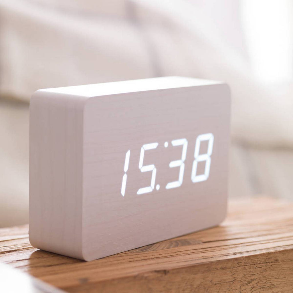 Gingko Design – Brick Click Alarm Clock - White / White LED, light wood digital alarm clock displaying the time on a wooden table