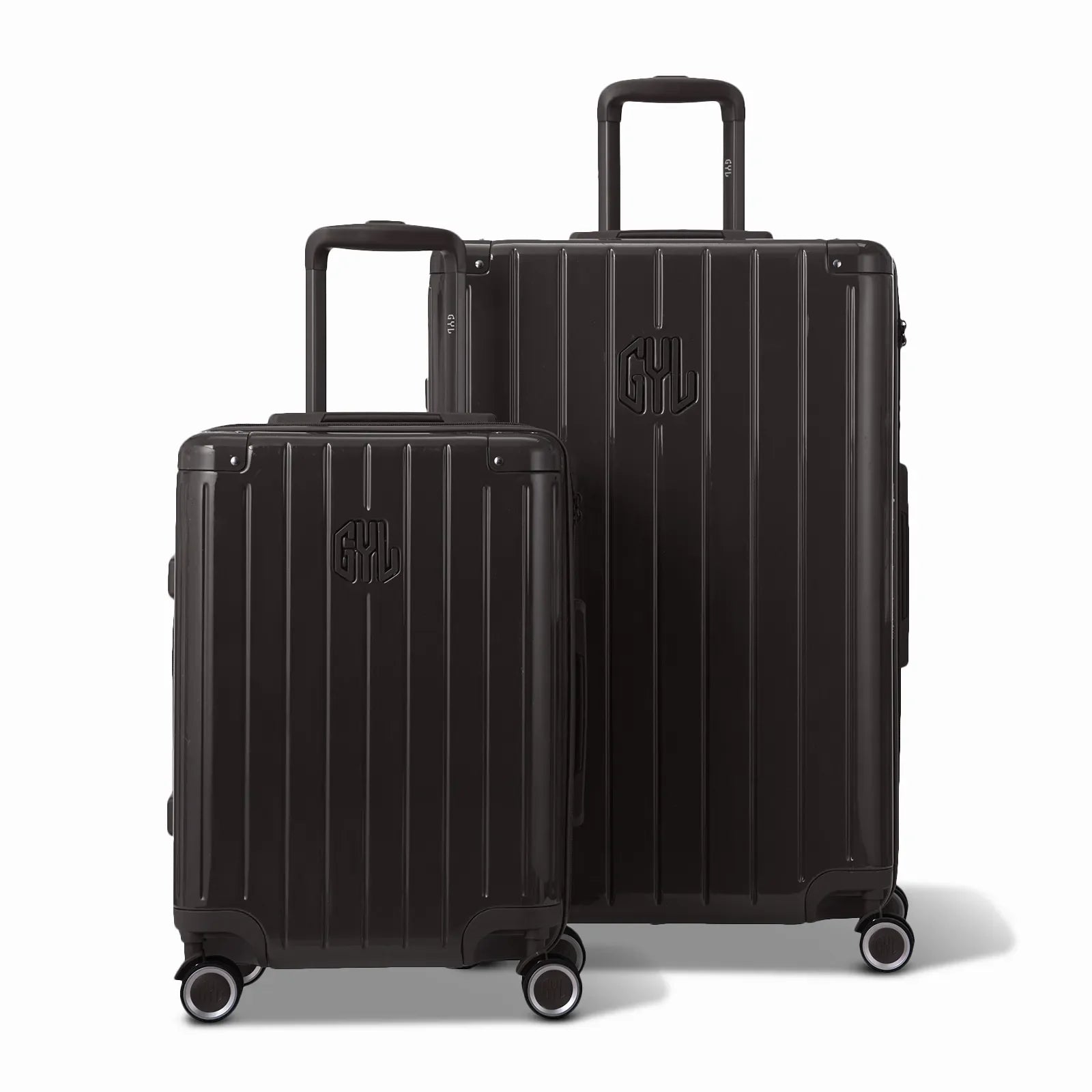 Two GYL Intemporelle black rigid suitcases, 2 formats, with extended trolley handle. #black_color