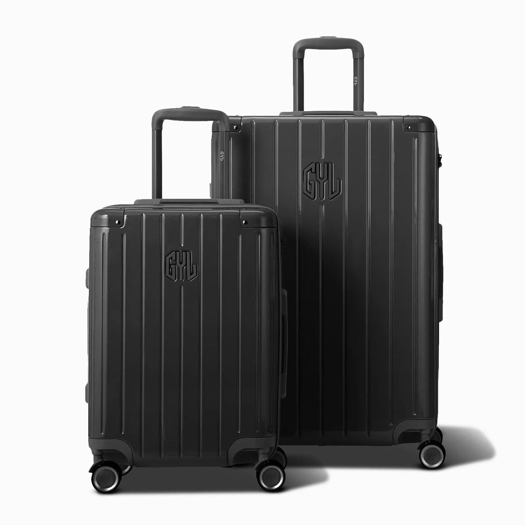 Two dark gray GYL Intemporelle rigid suitcases, cabin and hold format, with extended trolley handle. #color_dark gray