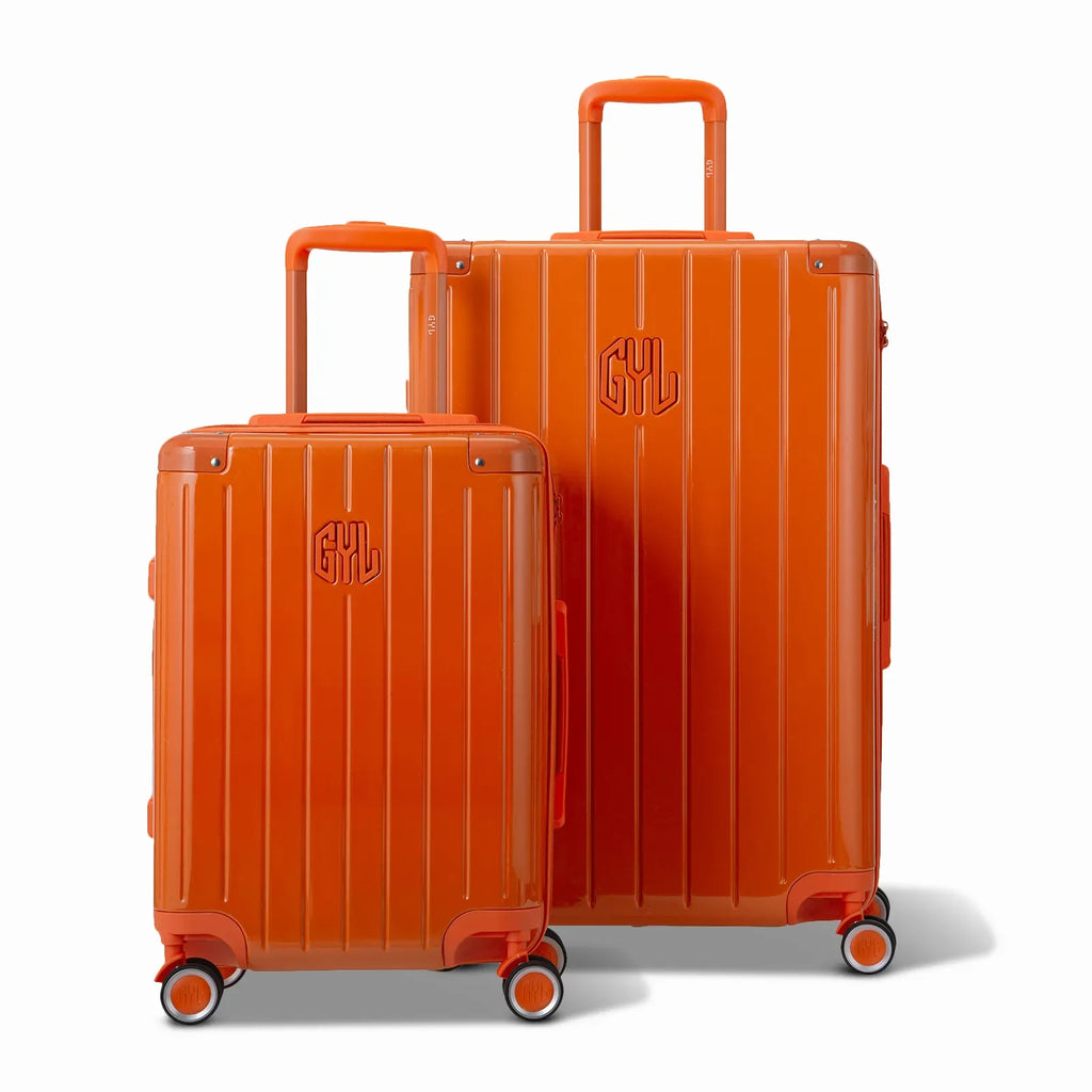 Two GYL Intemporelle orange rigid suitcases, 2 formats, with extended trolley handle. #dark_orange_color