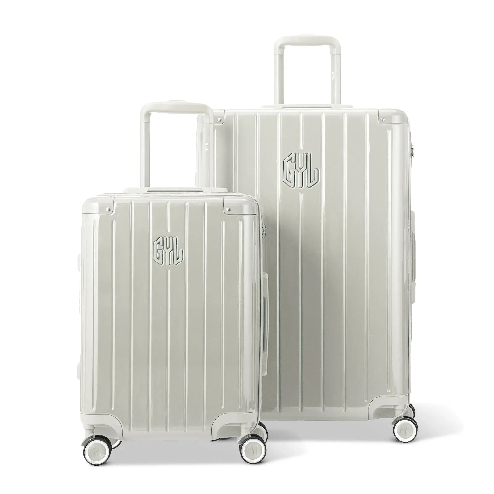 Two GYL Intemporelle sand hard suitcases, cabin and hold format, with extended trolley handle. #sand_color