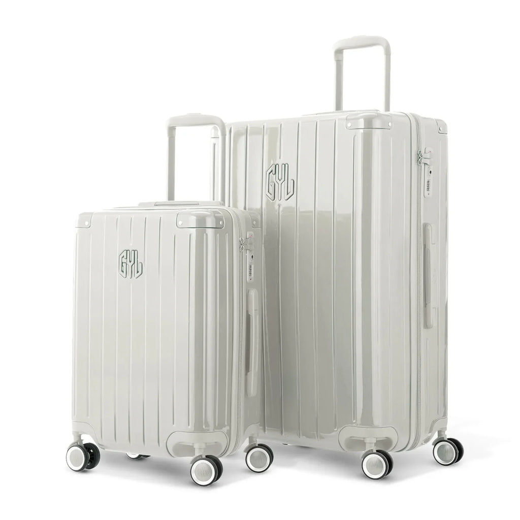 Duo of GYL Intemporelle sand hard suitcases with ribbed shells and telescopic handles. #sand_color