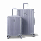 Two silver GYL Intemporelle rigid suitcases, cabin and hold format, with extended trolley handle. #silver_color
