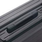 Rigid top handle of the dark gray GYL Intemporelle suitcase with embossed logo on the top. #color_dark gray