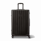 Front view of the GYL Intemporelle black rigid suitcase, embossed logo and 360 degree wheels. #black_color