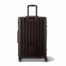 Rear view of the GYL Intemporelle black rigid suitcase with integrated handles and swivel casters. #black_color