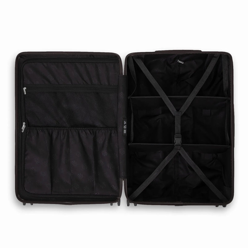 Compartmented interior of the black GYL Intemporelle suitcase with crossed straps and mesh pockets. #black_color