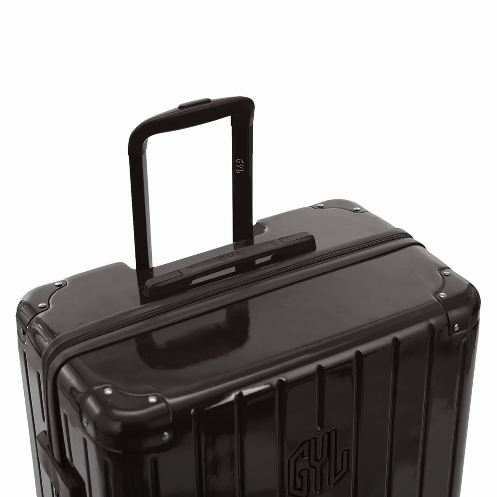 GYL telescopic trolley handle deployed on the Intemporelle black polycarbonate suitcase. #black_color