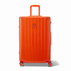 Front view of the GYL Intemporelle orange hard suitcase, embossed logo and 360 degree wheels. #dark_orange_color