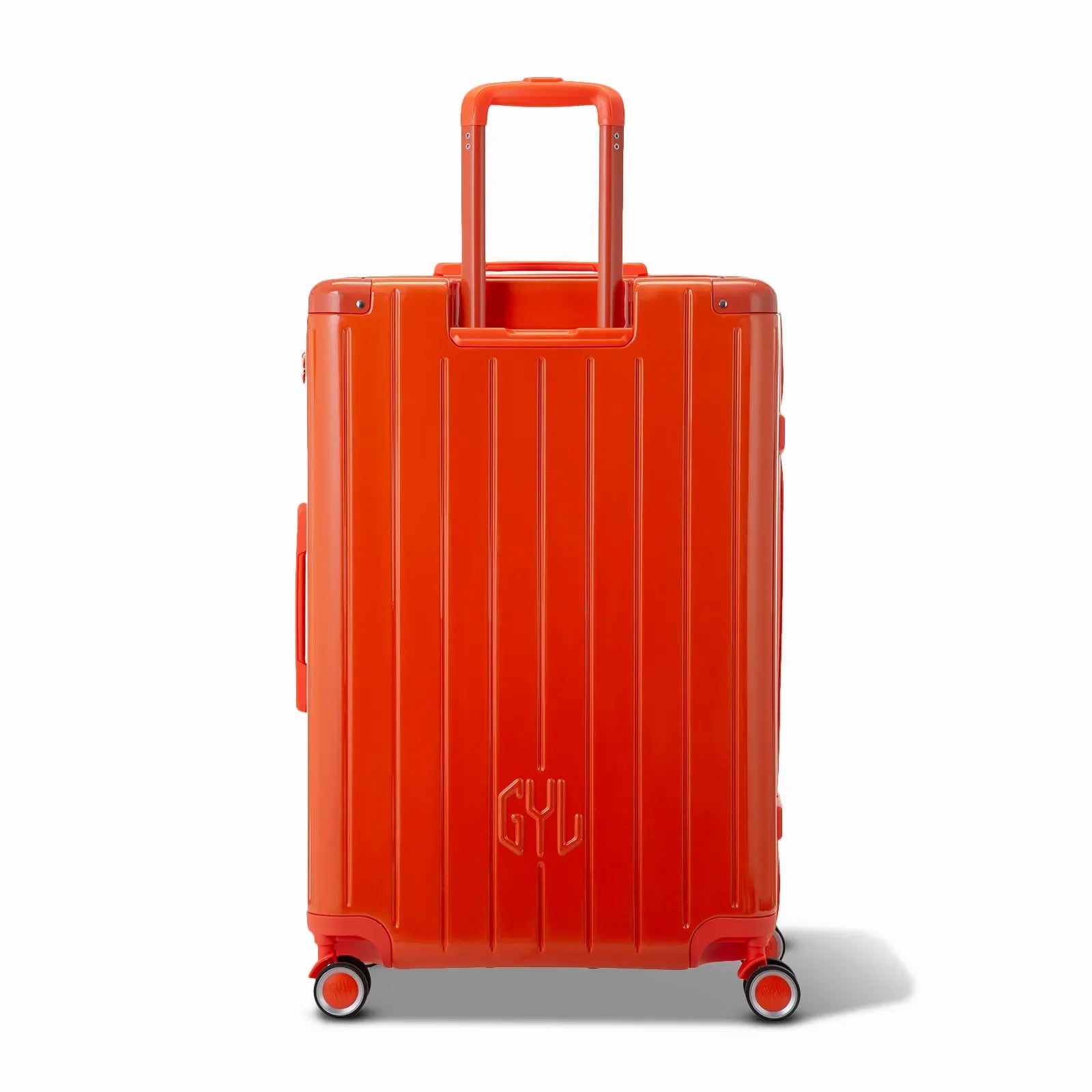 Rear view of the GYL Intemporelle orange hard suitcase with integrated handles and swivel casters. #dark_orange_color