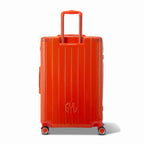 Vista trasera de la maleta rígida GYL Intemporelle naranja con asas integradas y ruedas giratorias. #couleur_orange foncé