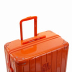 GYL telescopic trolley handle deployed on the Intemporelle orange polycarbonate suitcase. #dark_orange_color