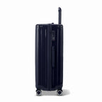 Side view of the GYL Intemporelle navy hard suitcase with telescopic handle and TSA closure. #navy_color
