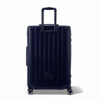 Rear view of the GYL Intemporelle navy hard suitcase with integrated handles and swivel casters. #navy_color