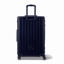 Rear view of the GYL Intemporelle navy hard suitcase with integrated handles and swivel casters. #navy_color