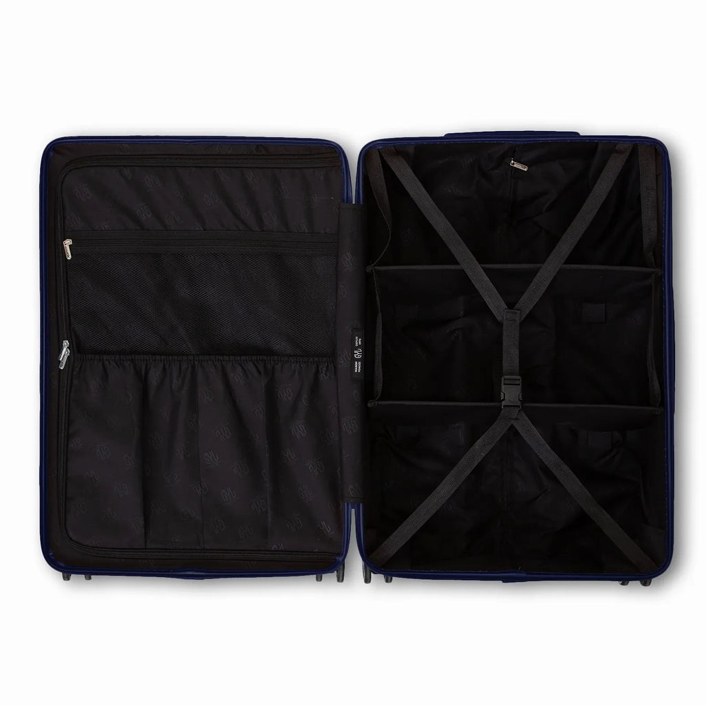 Compartmented interior of the GYL Intemporelle navy suitcase with crossed straps and mesh pockets. #navy_color