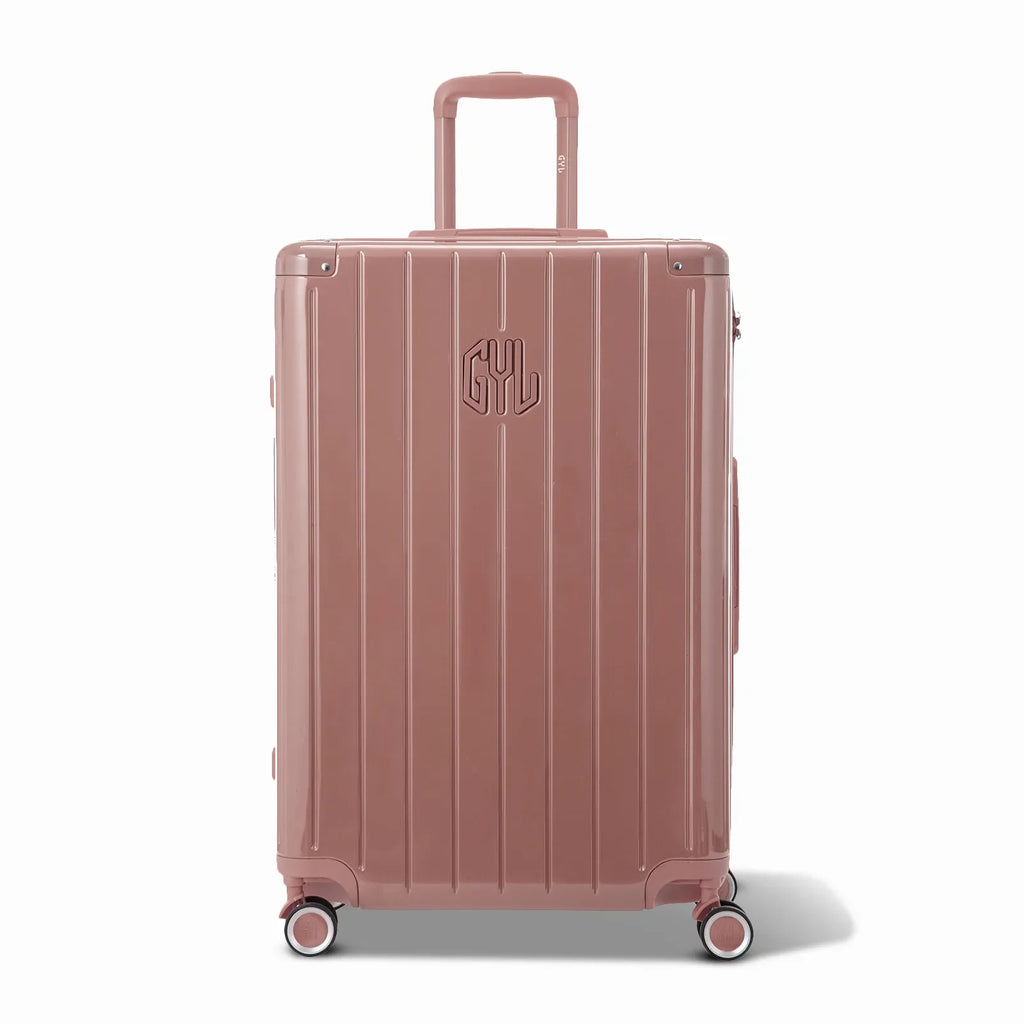 Front view of the GYL Intemporelle rose gold rigid suitcase, embossed logo and 360 degree wheels. #color_rose gold