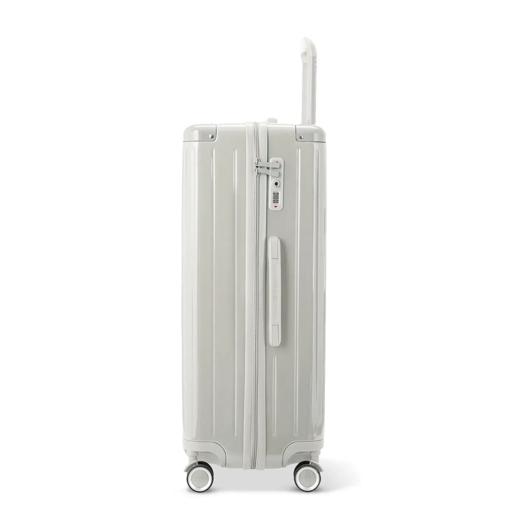 Side view of the GYL Intemporelle sand hard suitcase with telescopic handle and TSA closure. #sand_color