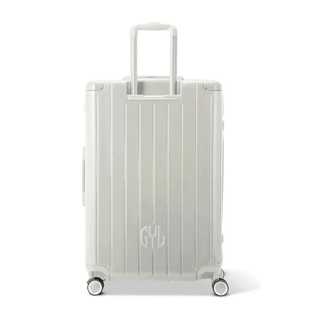 Rear view of the GYL Intemporelle sand hard suitcase with integrated handles and swivel casters. #sand_color