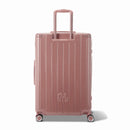 Rear view of the GYL Intemporelle rose gold rigid suitcase with integrated handles and swivel wheels. #color_rose gold