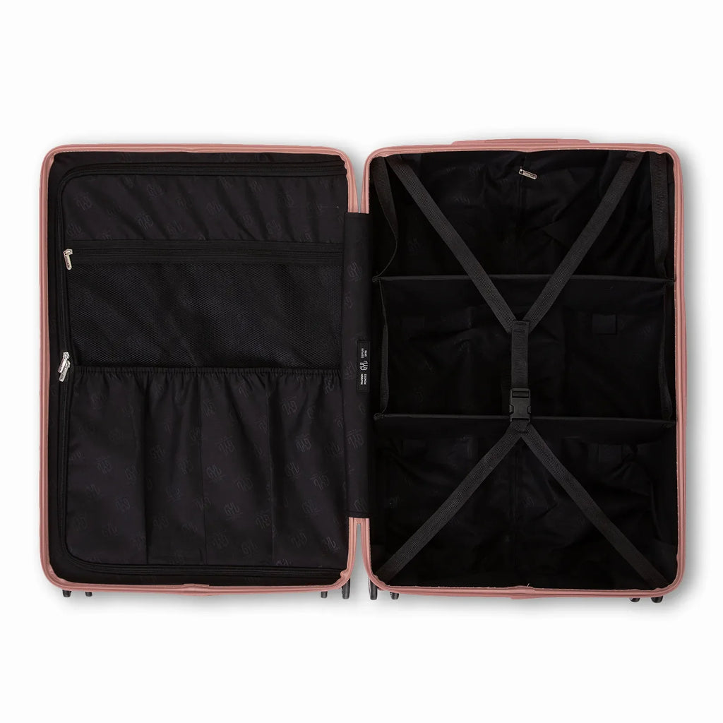 Compartmented interior of the GYL Intemporelle rose gold suitcase with crossed straps and mesh pockets. #color_rose gold