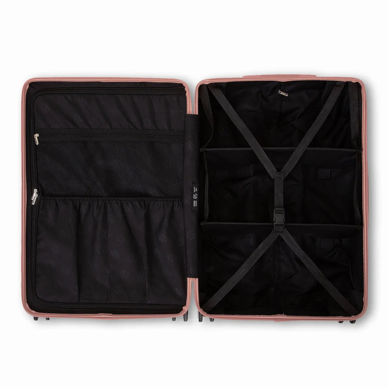 Compartmented interior of the GYL Intemporelle rose gold suitcase with crossed straps and mesh pockets. #color_rose gold
